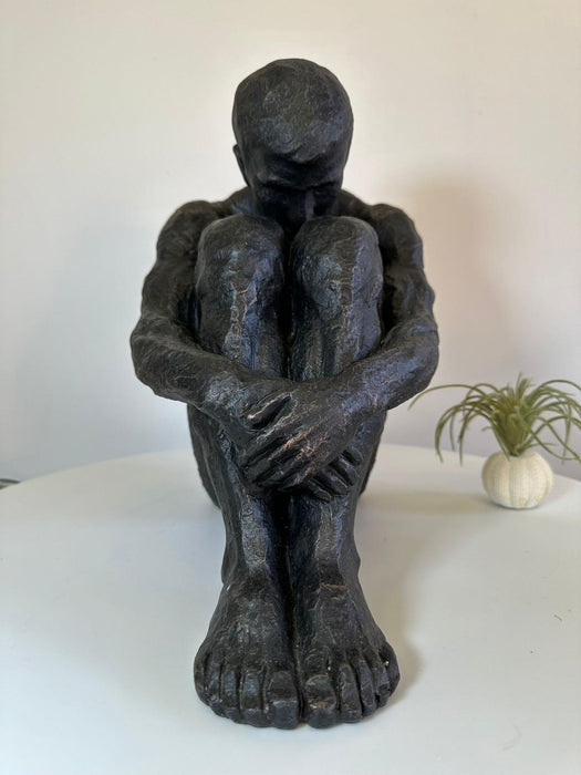 Aged Iron Sitting Man Sculpture