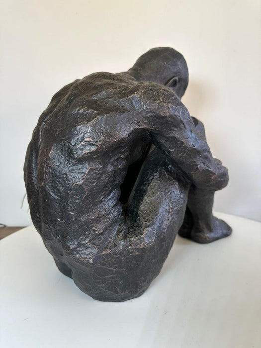 Aged Iron Sitting Man Sculpture